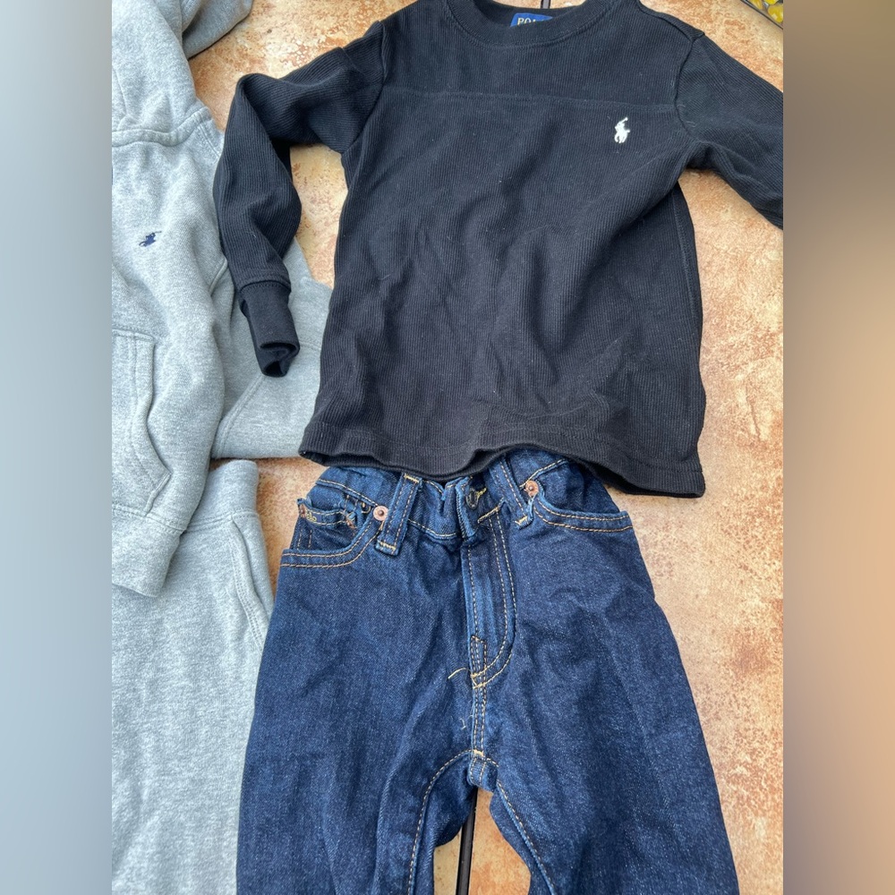 Ralph Lauren sweatsuit and black Ralph Lauren long sleeve with blue jeans.